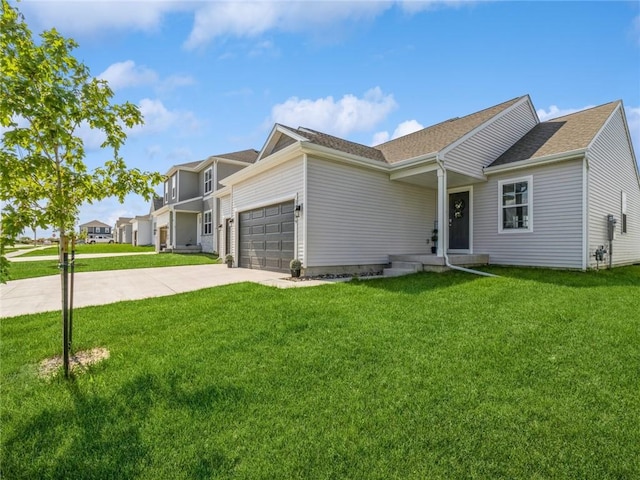 view of front of property featuring a garage, a front lawn, and driveway