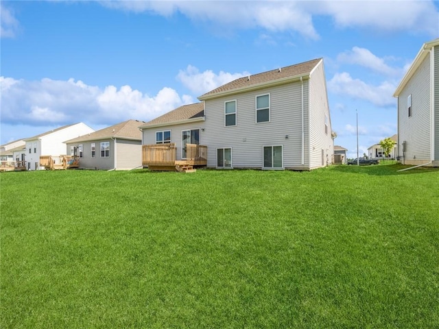 rear view of house with a wooden deck, a residential view, and a lawn