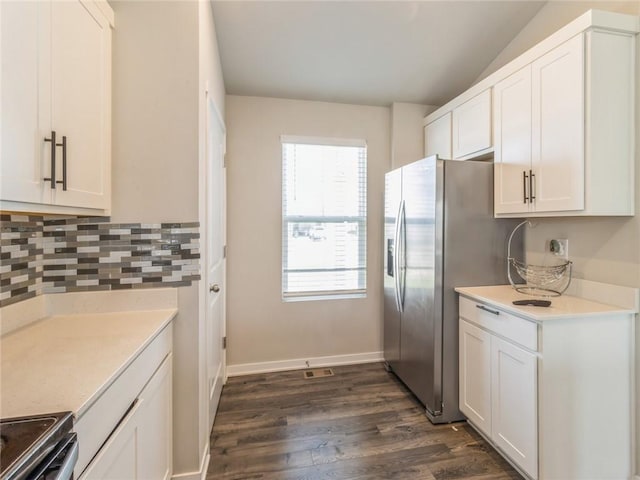 kitchen with backsplash, light countertops, stainless steel appliances, dark wood-style floors, and white cabinetry