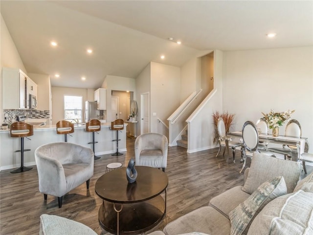 living area with recessed lighting, stairs, dark wood-type flooring, and vaulted ceiling