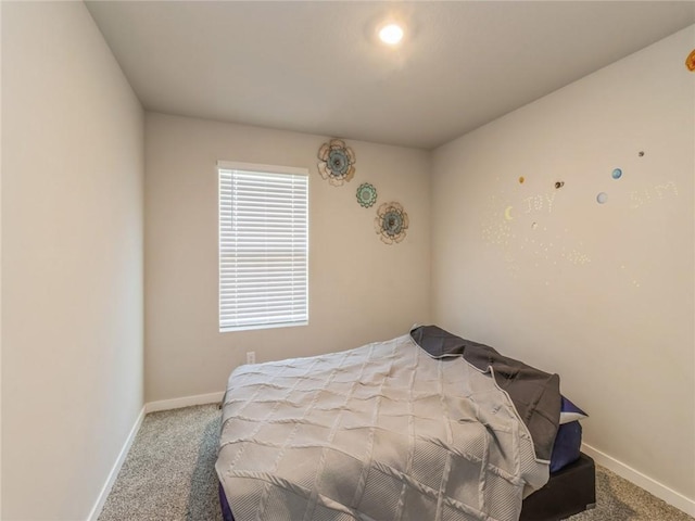 carpeted bedroom featuring baseboards