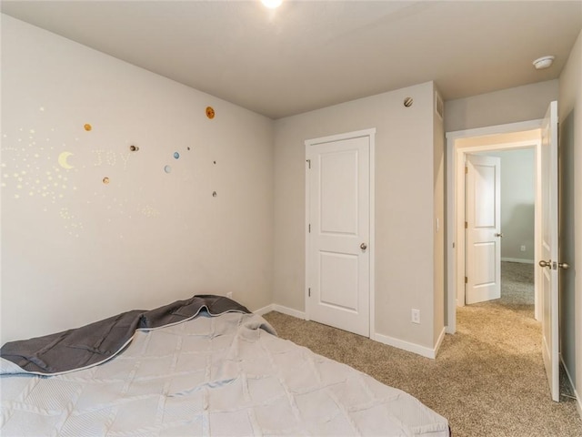 unfurnished bedroom featuring baseboards and carpet flooring