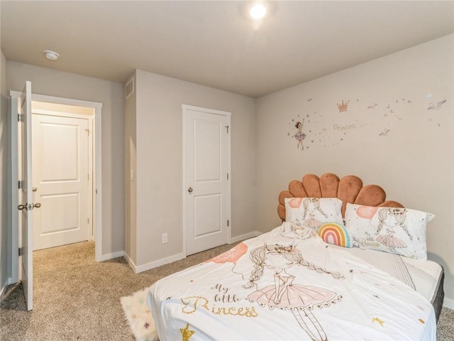 bedroom with baseboards, visible vents, and light carpet