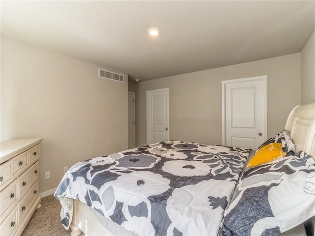 carpeted bedroom with baseboards and visible vents