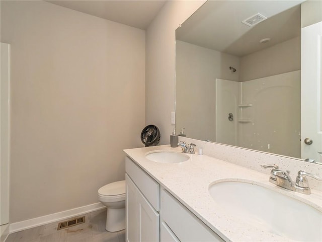 bathroom featuring a sink, visible vents, baseboards, and toilet