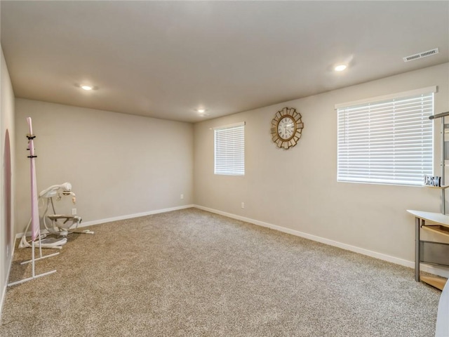 carpeted empty room with recessed lighting, baseboards, and visible vents