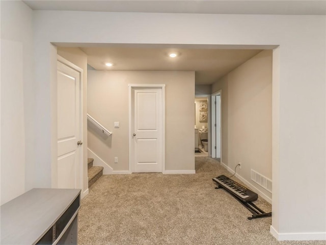 interior space featuring visible vents, baseboards, stairway, carpet flooring, and recessed lighting