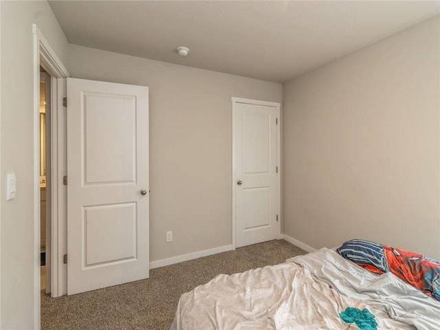 carpeted bedroom featuring baseboards