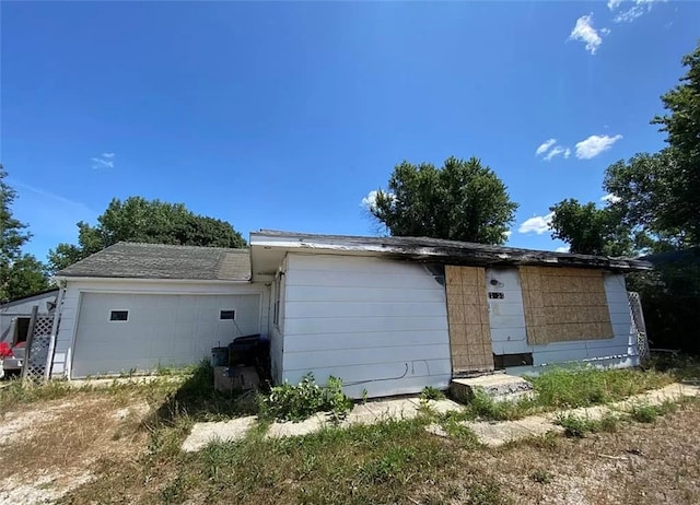 rear view of property featuring a garage