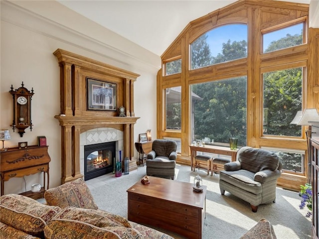 interior space with a tile fireplace and vaulted ceiling