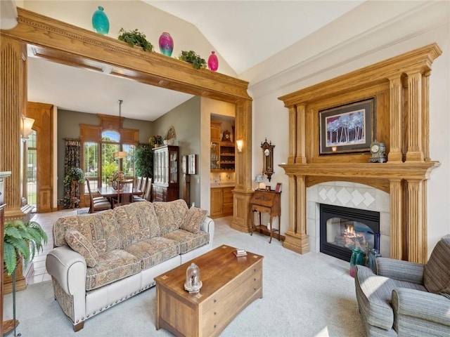 living room featuring light carpet and a tile fireplace