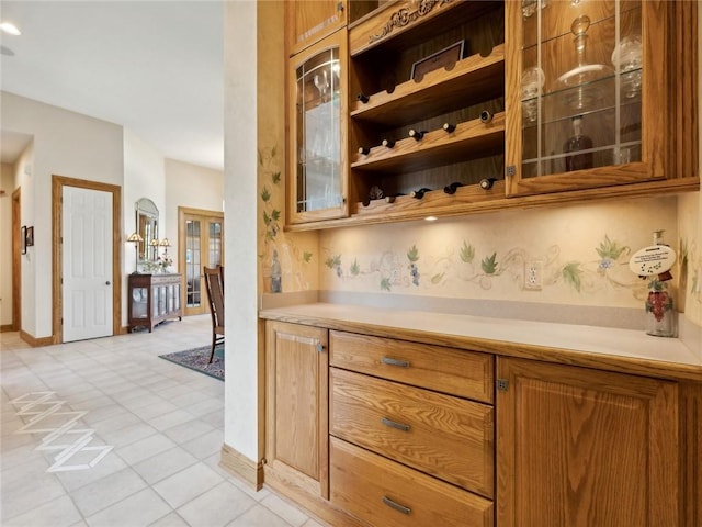 bar featuring light tile patterned flooring and french doors