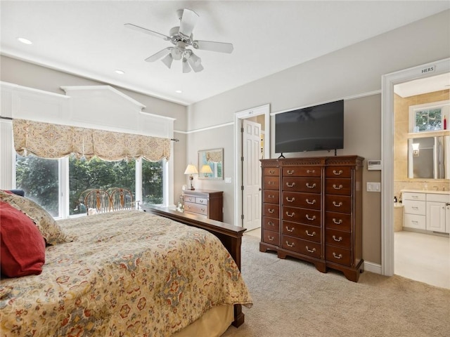 carpeted bedroom featuring ensuite bath and ceiling fan