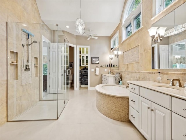 bathroom featuring vanity, tile patterned floors, ceiling fan, tile walls, and independent shower and bath