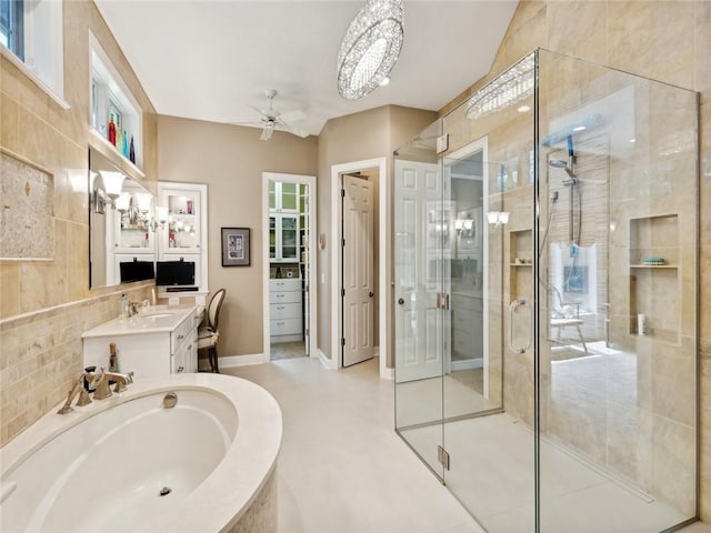 bathroom featuring separate shower and tub, backsplash, ceiling fan, and vanity