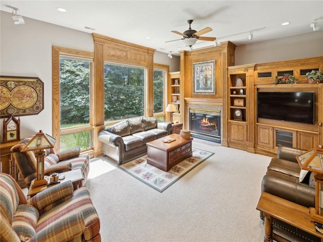 living room featuring ceiling fan, light carpet, and track lighting