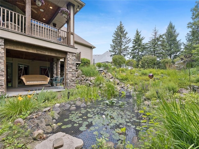 view of yard featuring a balcony and a patio area