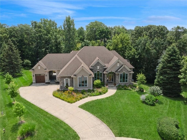 craftsman-style house featuring a garage and a front yard