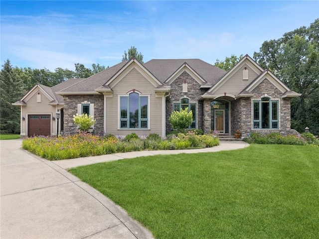 view of front of house featuring a front yard and a garage