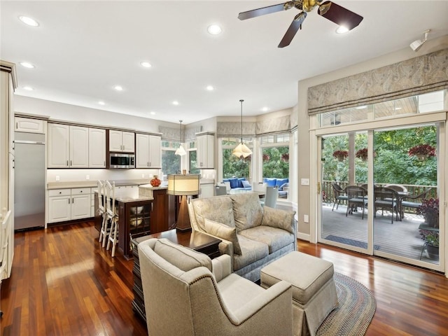 living room featuring dark hardwood / wood-style flooring and ceiling fan