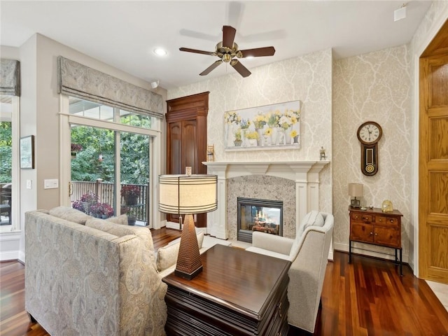 sitting room featuring dark hardwood / wood-style floors, ceiling fan, and a fireplace