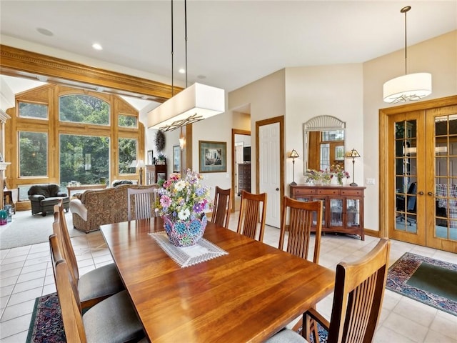 dining area featuring french doors, light tile patterned floors, and lofted ceiling