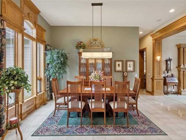 tiled dining area featuring decorative columns