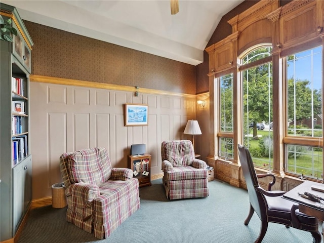 living area with carpet flooring and vaulted ceiling