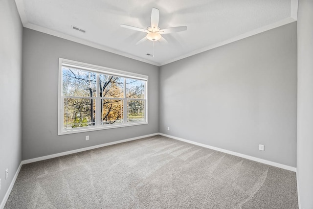 carpeted spare room with ceiling fan and crown molding