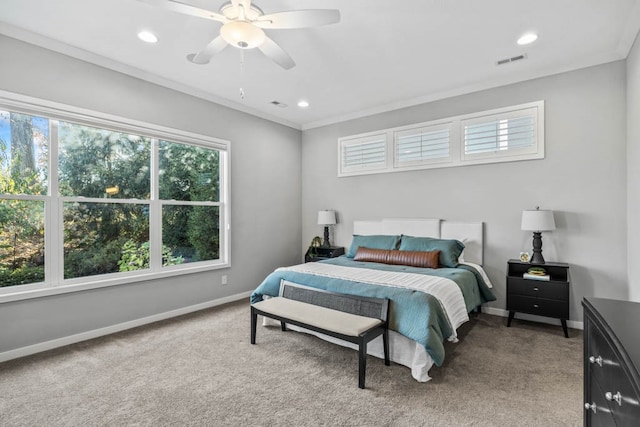 carpeted bedroom with ceiling fan and crown molding