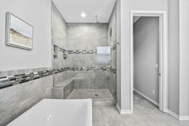 bathroom featuring tile patterned flooring and plus walk in shower