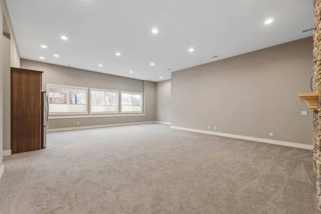 unfurnished living room with light colored carpet