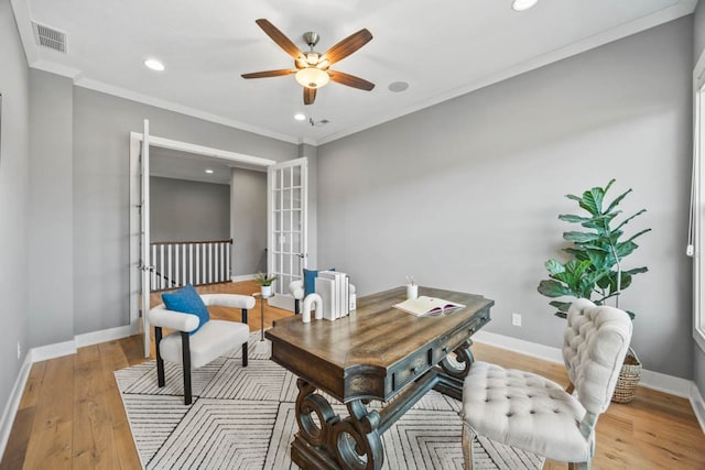 home office with ceiling fan, light wood-type flooring, crown molding, and french doors