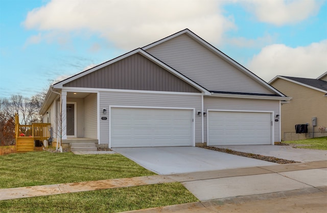 view of front of property with a front yard and a garage