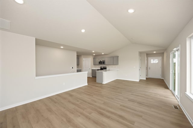 800 Linden St, Carlisle, IA 50047 - unfurnished living room featuring light wood-style floors, vaulted ceiling, baseboards, and recessed lighting