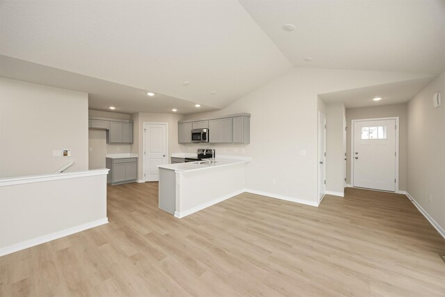 800 Linden St, Carlisle, IA 50047 - kitchen featuring gray cabinetry, stainless steel appliances, a peninsula, lofted ceiling, and recessed lighting