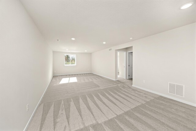 800 Linden St, Carlisle, IA 50047 - empty room featuring light colored carpet, baseboards, and recessed lighting