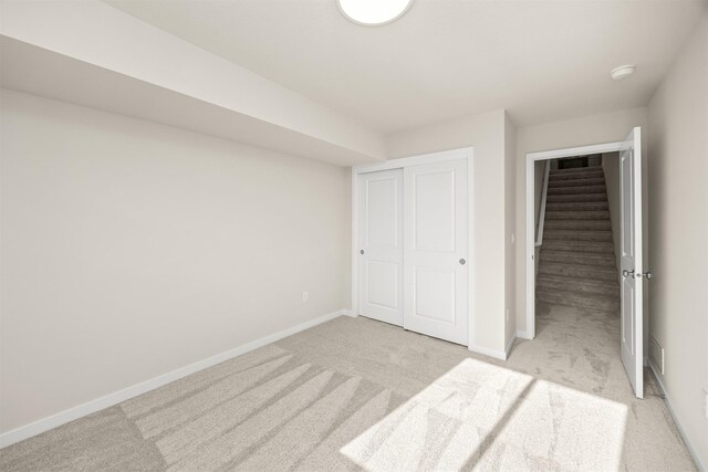 800 Linden St, Carlisle, IA 50047 - unfurnished bedroom with light colored carpet, baseboards, and a closet