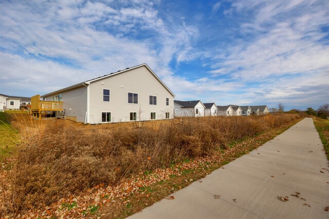 view of property exterior featuring a wooden deck