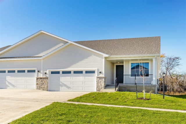 ranch-style home with a front lawn, a garage, and covered porch