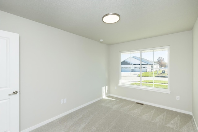 6570 NE 11th Ct, Des Moines, IA 50313 - unfurnished room with baseboards and light colored carpet