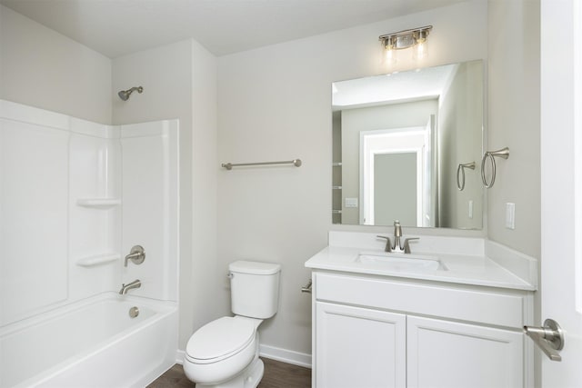 6570 NE 11th Ct, Des Moines, IA 50313 - full bathroom with toilet, vanity, shower / tub combination, baseboards, and wood finished floors
