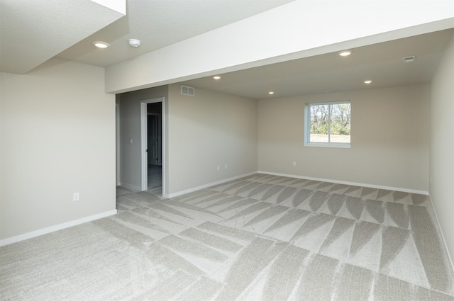 6570 NE 11th Ct, Des Moines, IA 50313 - basement with light carpet, baseboards, and recessed lighting