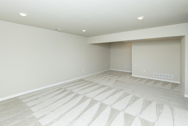 6570 NE 11th Ct, Des Moines, IA 50313 - finished basement featuring light colored carpet, baseboards, and recessed lighting
