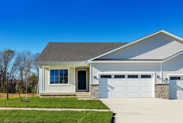 view of front of house featuring a garage and a front lawn