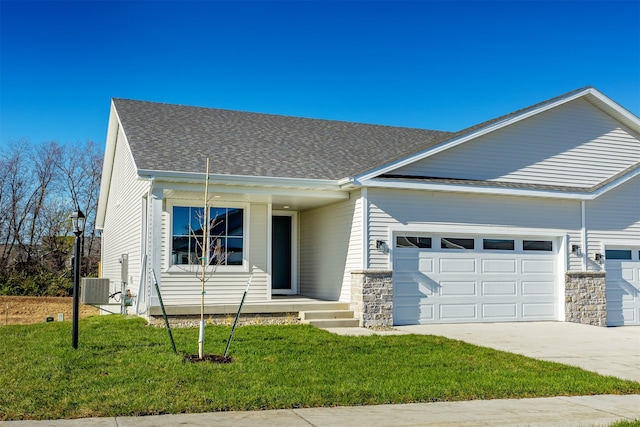 ranch-style home with a garage, central AC, and a front lawn