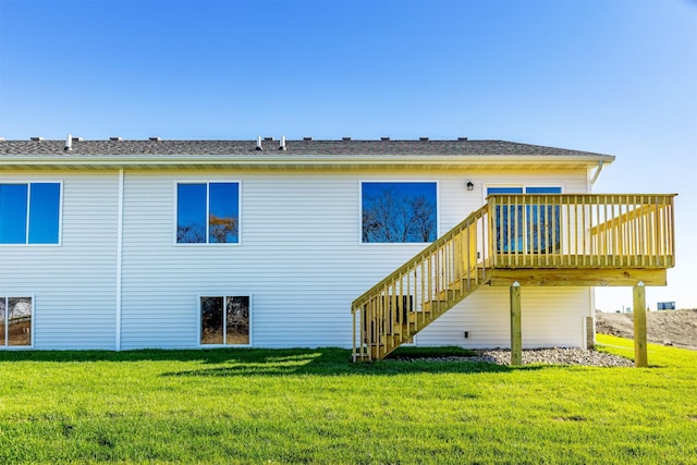 6570 NE 11th Ct, Des Moines, IA 50313 - rear view of property with stairs, a lawn, and a deck