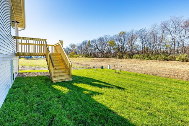 6570 NE 11th Ct, Des Moines, IA 50313 - view of grassy yard with stairway and a wooden deck