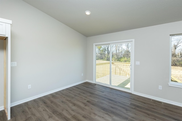 6570 NE 11th Ct, Des Moines, IA 50313 - unfurnished room with dark wood finished floors, healthy amount of natural light, vaulted ceiling, baseboards, and recessed lighting