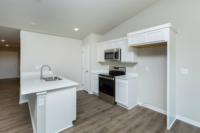 6570 NE 11th Ct, Des Moines, IA 50313 - kitchen with stainless steel appliances, a sink, wood finished floors, light countertops, and white cabinets
